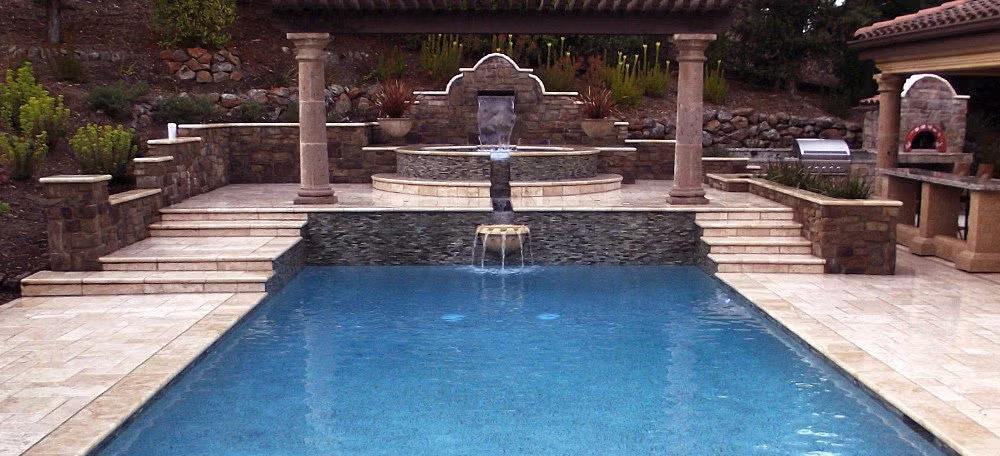 An outdoor residential pool with a tiered water cascade and gazebo in the East Bay & Bay Area