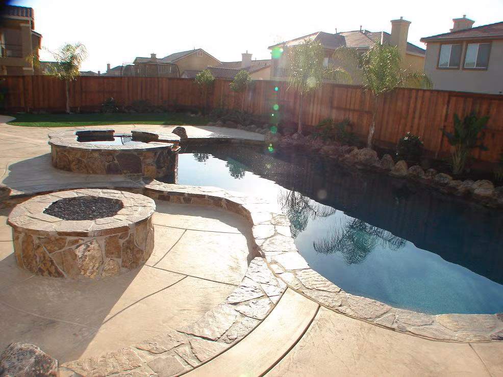 A Custom Freeform Swimming Pool with Curved Edges and Expansive Stone Decking in the Bay Area