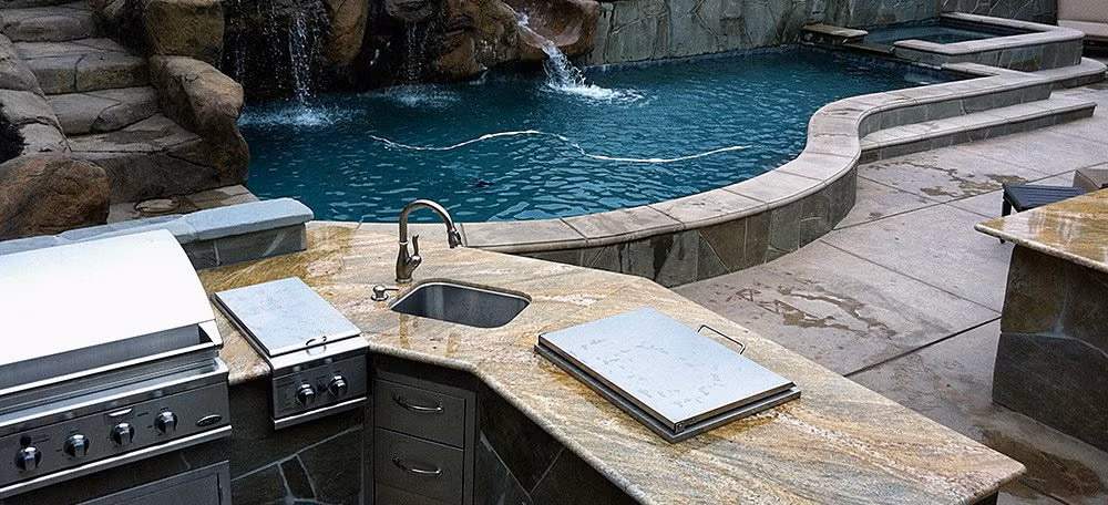 A Custom Pool Featuring Cascading Rock Waterfalls and a Built-In Outdoor Kitchen in the Bay Area