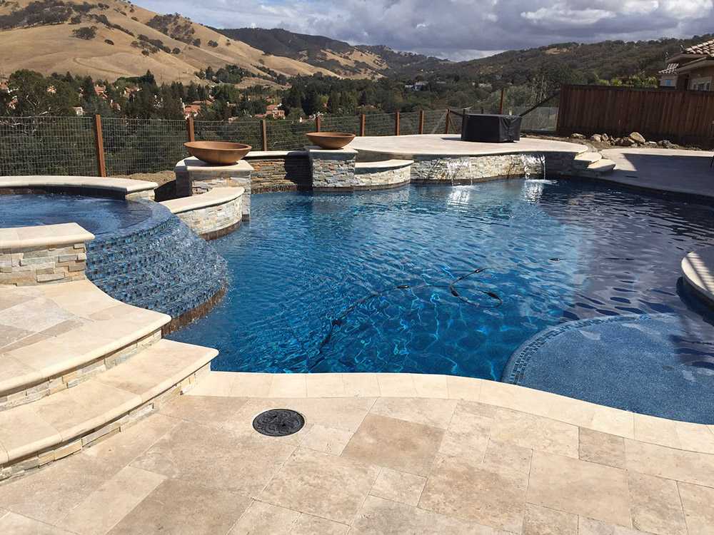 A Luxury Freeform Swimming Pool with a Raised Spa and Cascading Water Features in the Bay Area